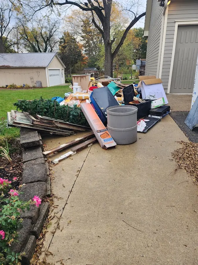 Dumpster being loaded with debris for 10 Yard Dumpster Rental in Cambria